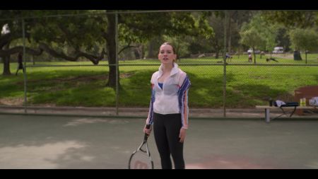 love quinn holding a tennis racket 